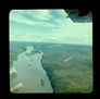 Approaching the Bitumount airstrip from the southwest; Bitumount is visible at centre on the east bank of the Athabasca River, ca. 1950.<br/>Source: University of Alberta Archives, 91-137-076