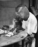 Working in the machine shop, Alberta Government Oil Sands Project, repairing teeth for the excavator, ca. 1950; digging up the very abrasive oil sands quickly wore down the teeth of the bucket on the excavator.<br/>Source: Provincial Archives of Alberta, PR1991.0359.12