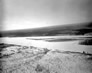 The Athabasca River, with the Alberta Government Oil Sands Project buildings on the left and some of the International Bitumen Company visible at centre, n.d.<br/>Source: Provincial Archives of Alberta, PA410.1