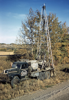 An Imperial Oil seismic truck drills a shot hole in the summer of 1950. A small explosive would be detonated in the shot hole, and the sound waves measured by other seismic equipment in the area. 