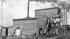 A revised and enlarged version of Karl Clark’s model plant was constructed at Dunvegan Yards in north Edmonton in 1924 and modified in 1925. The land belonged to the Edmonton, Dunvegan and British Columbia Railway. It was conveniently adjacent to a spur line from the Alberta and Great Waterways Railway, providing a direct connection to the A&GWR’s northern terminus at Waterways, a few miles from Fort McMurray. In 1929, this plant was disassembled, loaded on train cars and moved to a site on the Clearwater River near Waterways. Source: Provincial Archives of Alberta, A3526