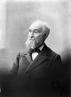 John Macoun, January 1902; in his official report for the Geological Survey of Canada, Macoun recounts that on September 7, 1875, he "…observed a bed of tar conglomerate about thirty feet above the river. There was sand above and below it, and the ooze along the shore both at this point and in many places below, looked like the ooze from petroleum springs….The tar conglomerate was frequently observed, sometimes forming a bed two feet thick.". Source: Topley Studio/Library and Archives Canada, PA-033784