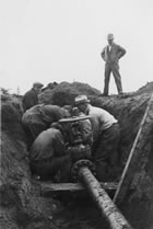 View of pipeline construction, Turner Valley area, Alberta, May 1938; the coming in of a number of wells spurred a whole new era of pipeline construction. <br />Source: Glenbow Archives, IP-6e-1-63