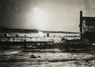 The fire at the Royalite No. 4 well burned for weeks before being extinguished by a team of experts from the Oklahoma oil fields, November 1924. <br />Source: Glenbow Archives, IP-6e-4-18