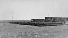 Pipe is unloaded from Canadian Pacific Railway cars for the pipeline between Turner Valley and Calgary, ca. 1920-1929. <br />Source: Glenbow Archives, NA-4859-3